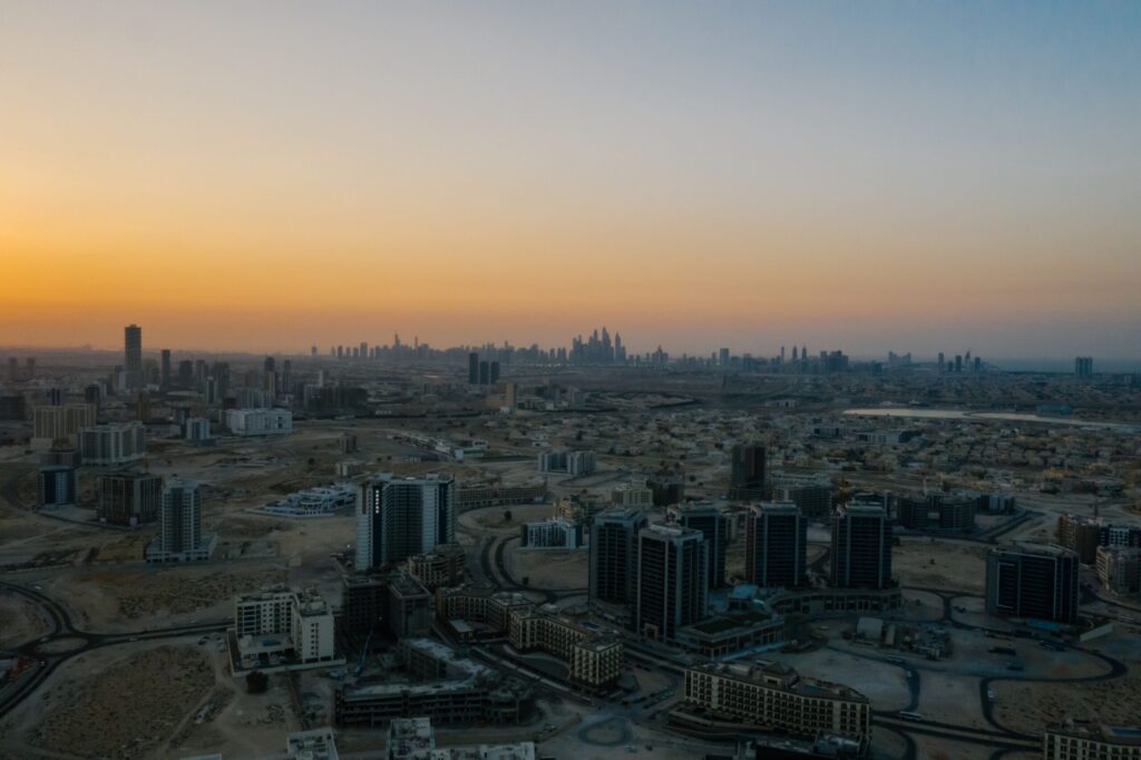 Aerial view of a Dubai residential district and skyline at dawn