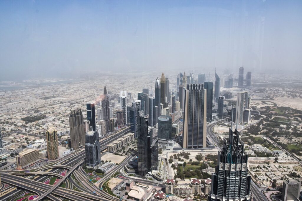 Aerial view of the Dubai skyline with residential and office towers and highways