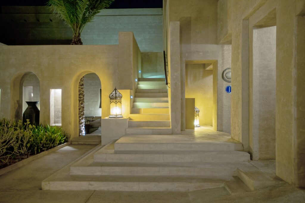 Modern gated villa exterior with landscaped garden, representative of a Dubai Hills Estate villa community near Club Villas