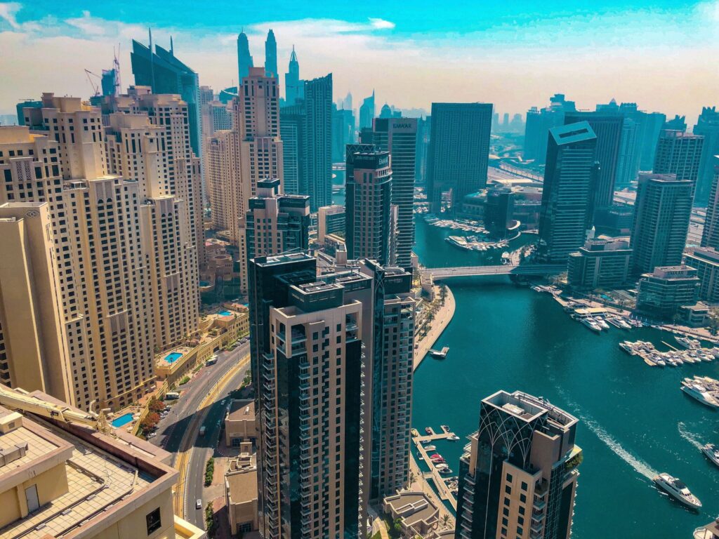 Aerial daytime view of Dubai Marina's skyscrapers and canal near Orra Marina