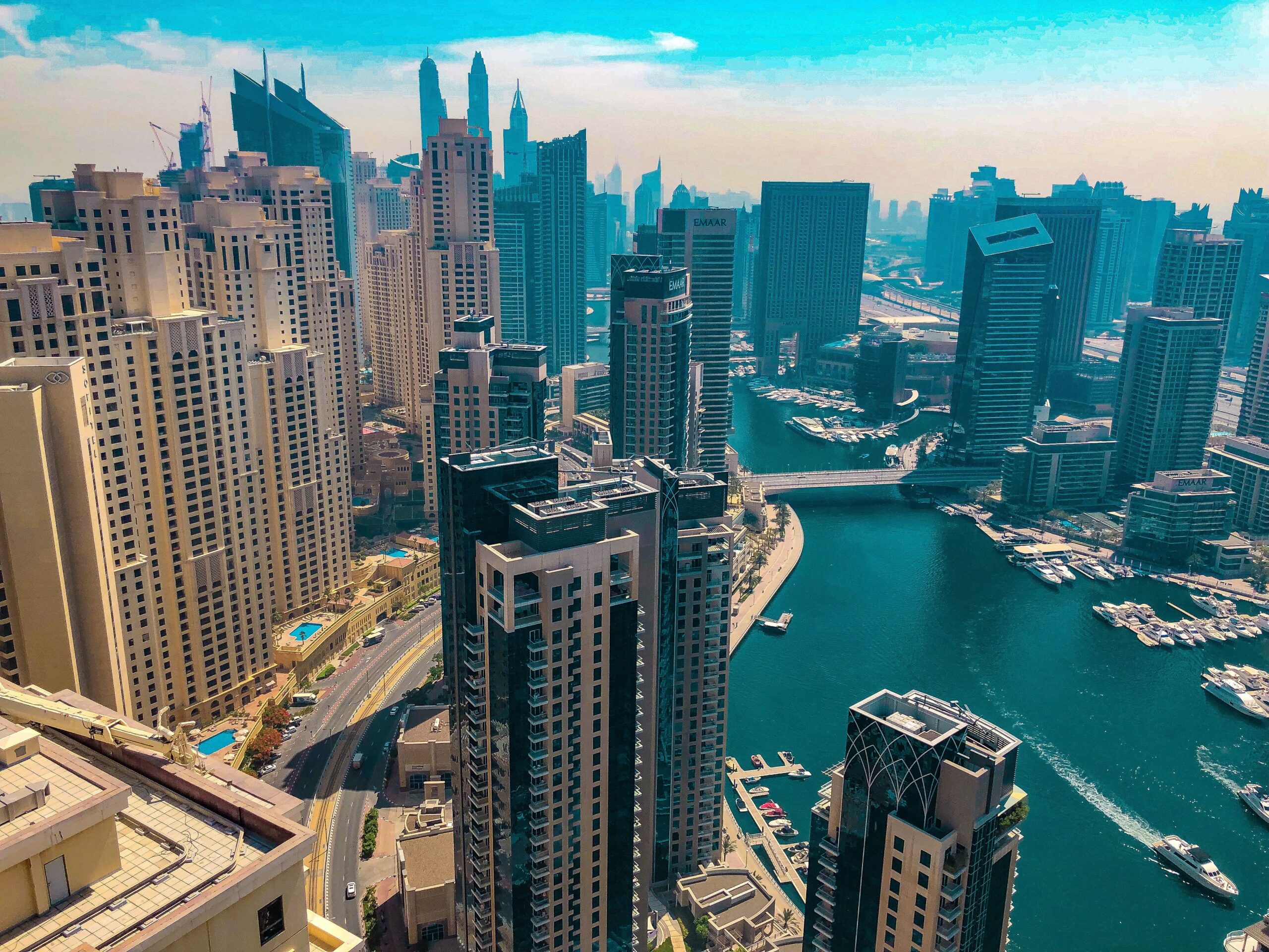 Aerial daytime view of Dubai Marina's canal and residential towers surrounding Marina Sail
