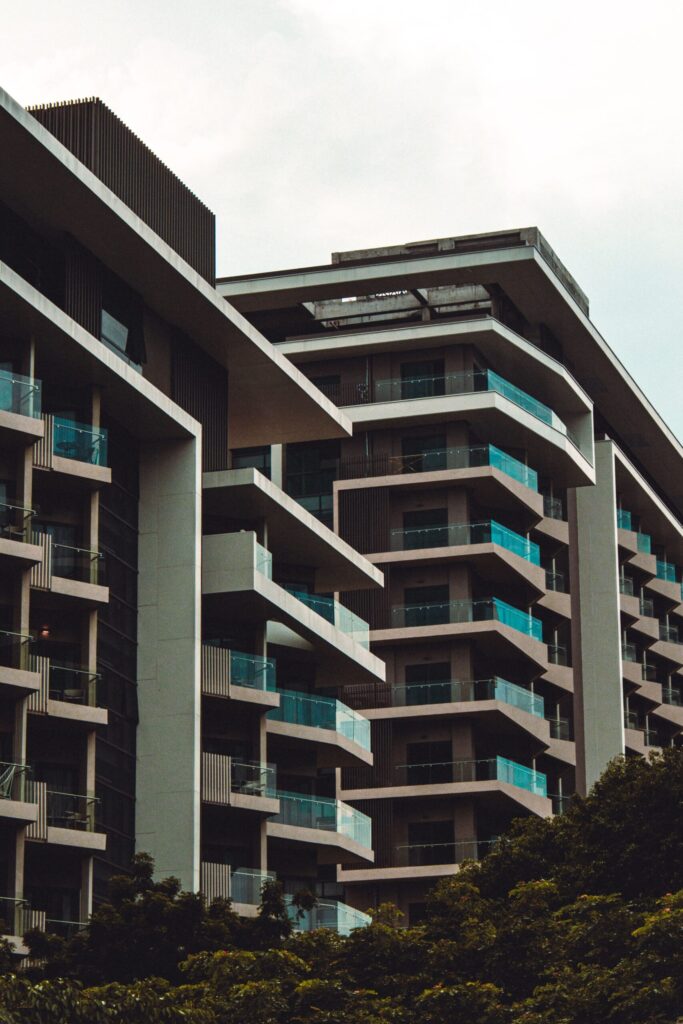 Modern staggered-balcony residential complex with glass railings in Dubai