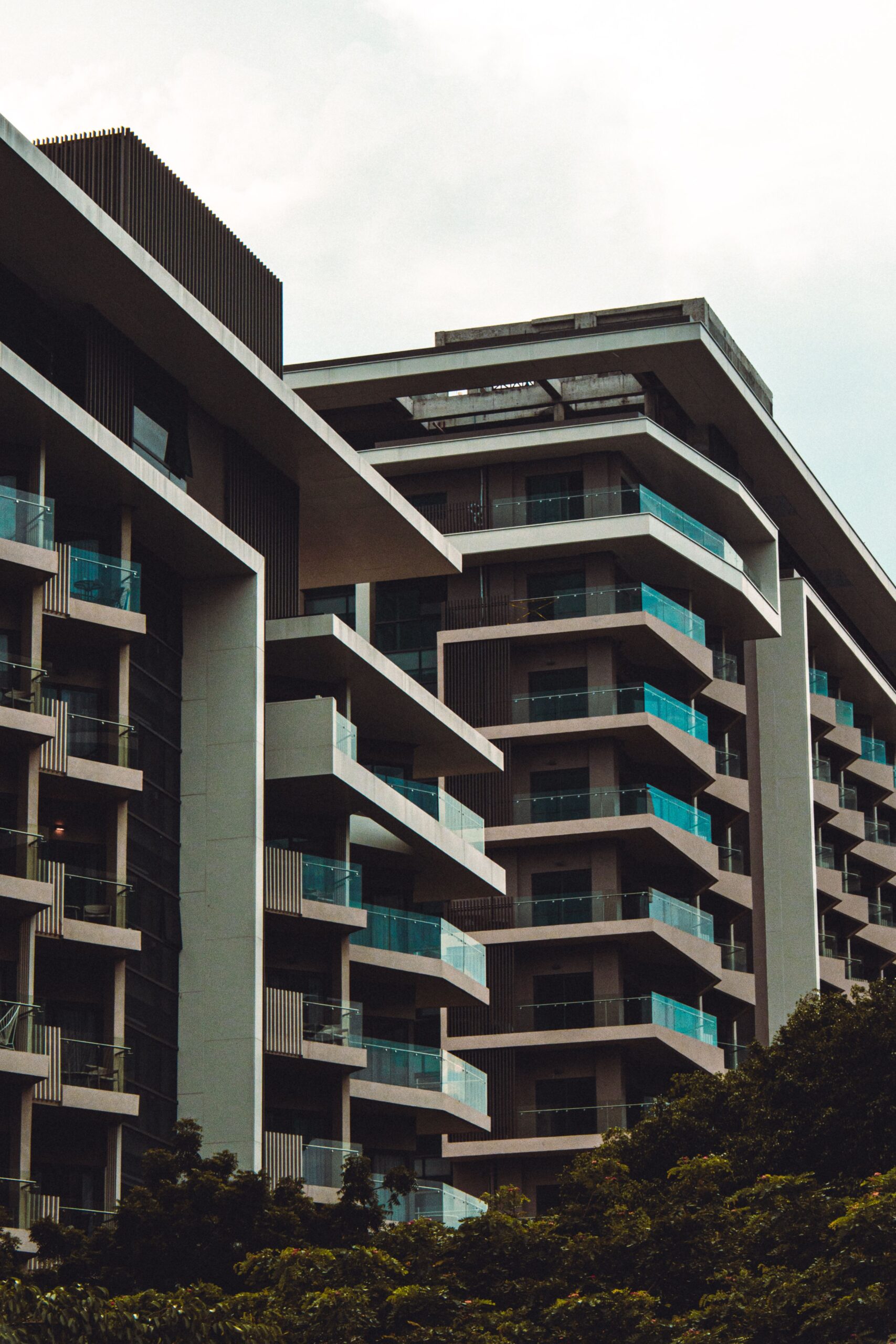 Modern staggered-balcony residential complex with glass railings in Dubai