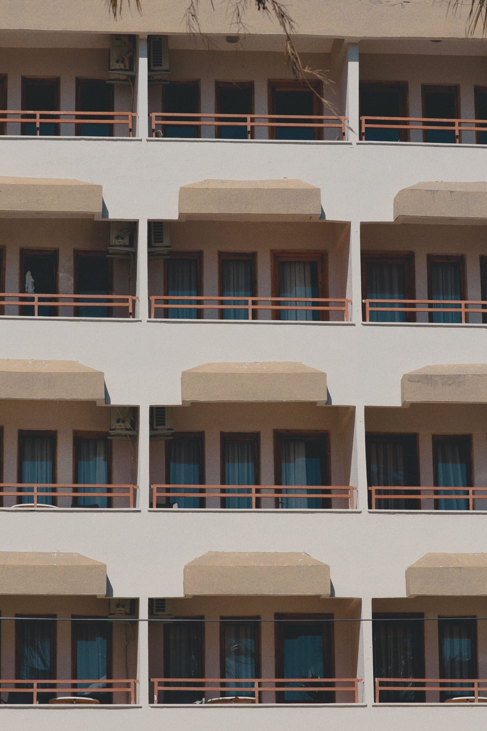 Cream low-rise Dubai apartment facade with repeating balconies and terracotta railings, representative of Prime Residency's Spain Cluster architecture in International City