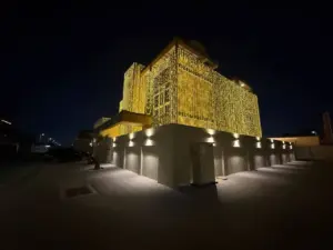 Villa in Nad Al Sheba at night, its front covered in warm string lights above a wall with downlights