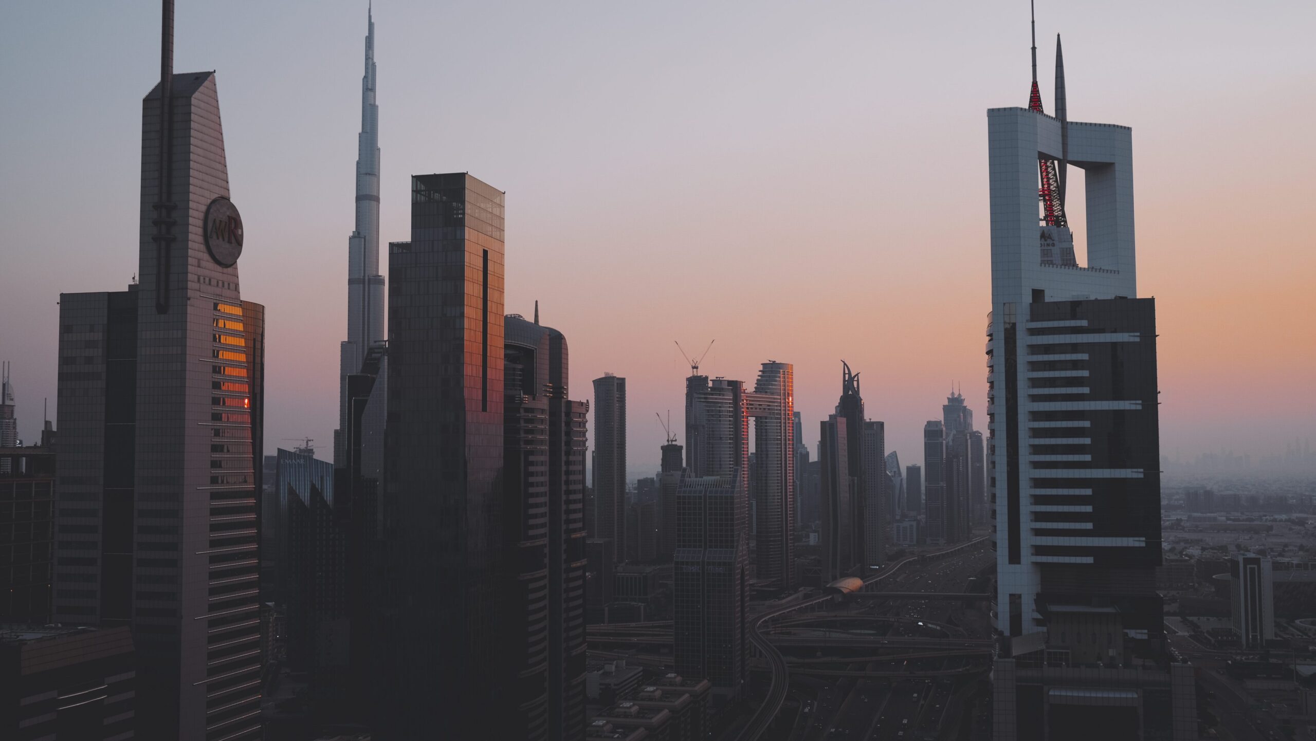 Dubai skyscrapers at sunset above a hazy skyline