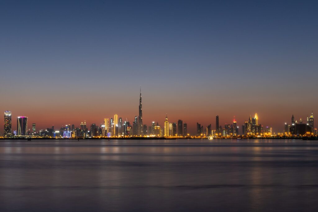 Dubai skyline across the water at dusk with Burj Khalifa